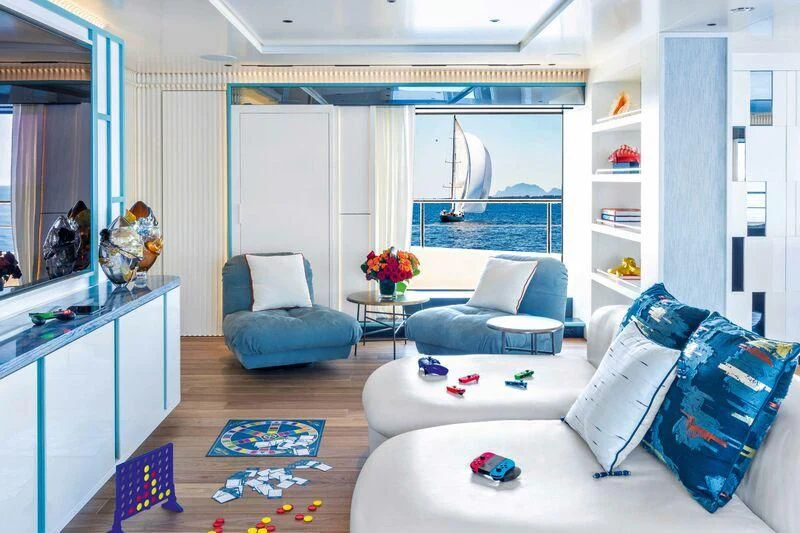 a living room with a blue couch and a rug aboard RIO Yacht for Sale