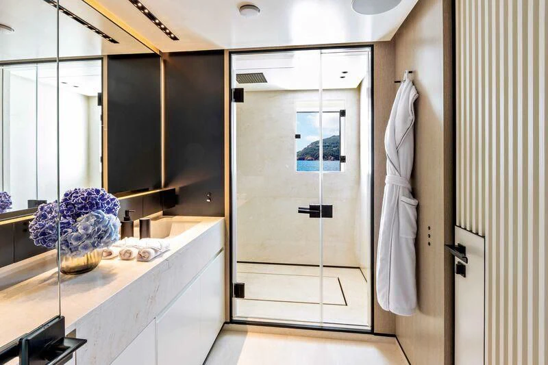 a bathroom with a large mirror aboard RIO Yacht for Sale