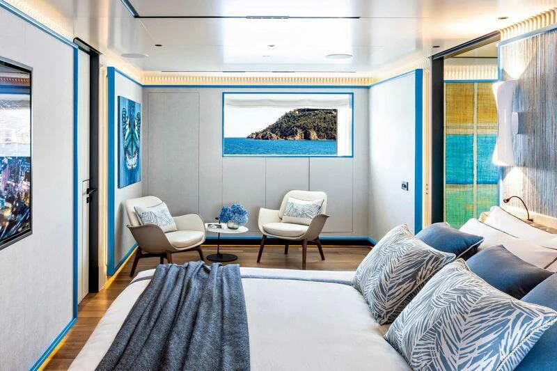 a room with a couch and a chair and a television aboard RIO Yacht for Sale