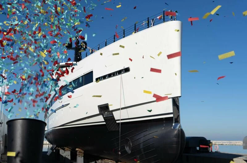 a large boat with a lot of flags on it aboard RIO Yacht for Sale