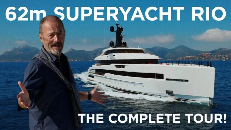 a man standing next to a boat aboard RIO Yacht for Sale