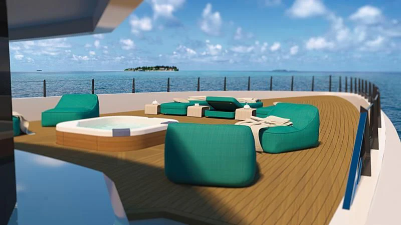 a deck with chairs and a body of water in the background aboard RIO Yacht for Sale