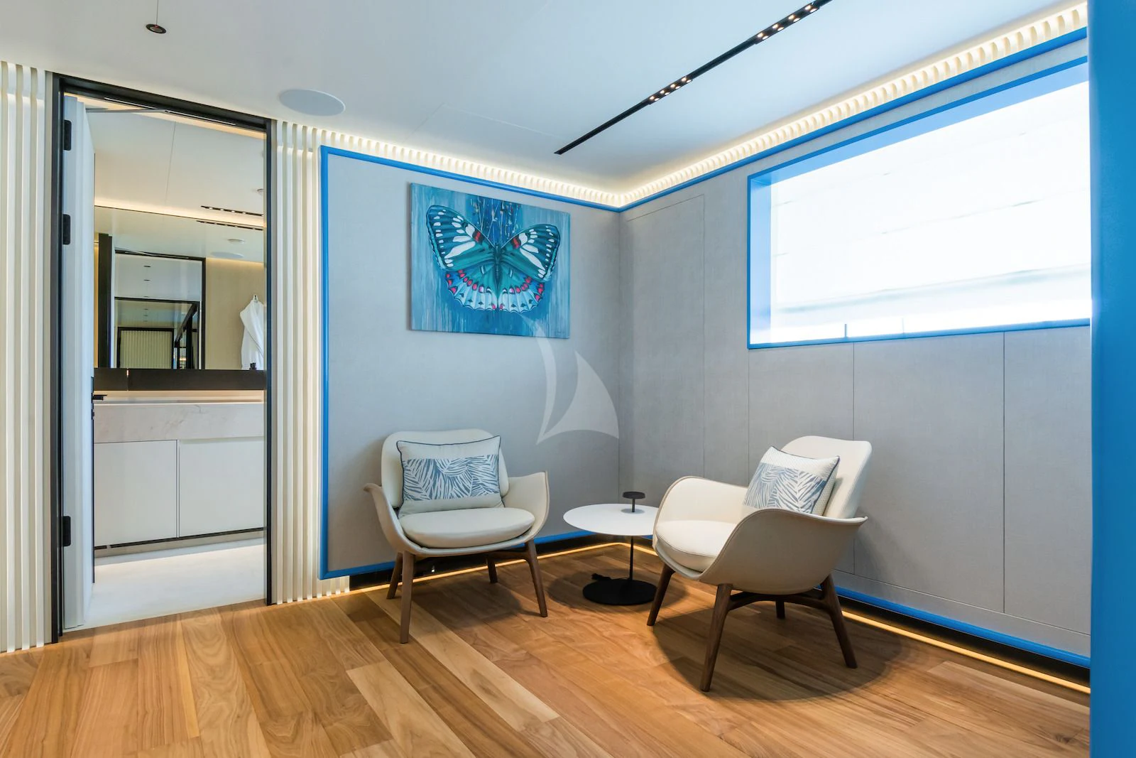 a room with a wood floor and a painting on the wall aboard RIO Yacht for Sale