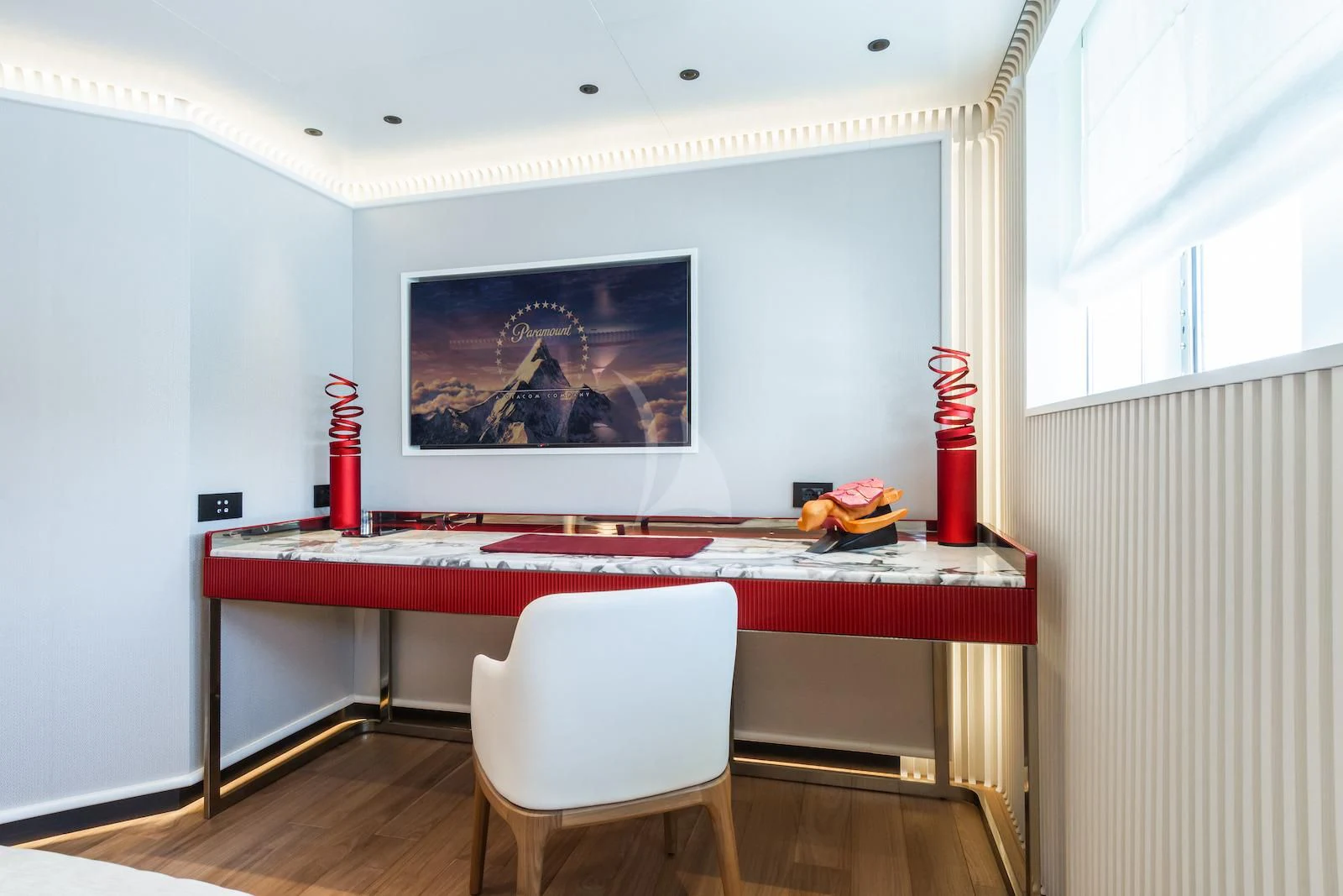 a room with a table and a tv on the wall aboard RIO Yacht for Sale