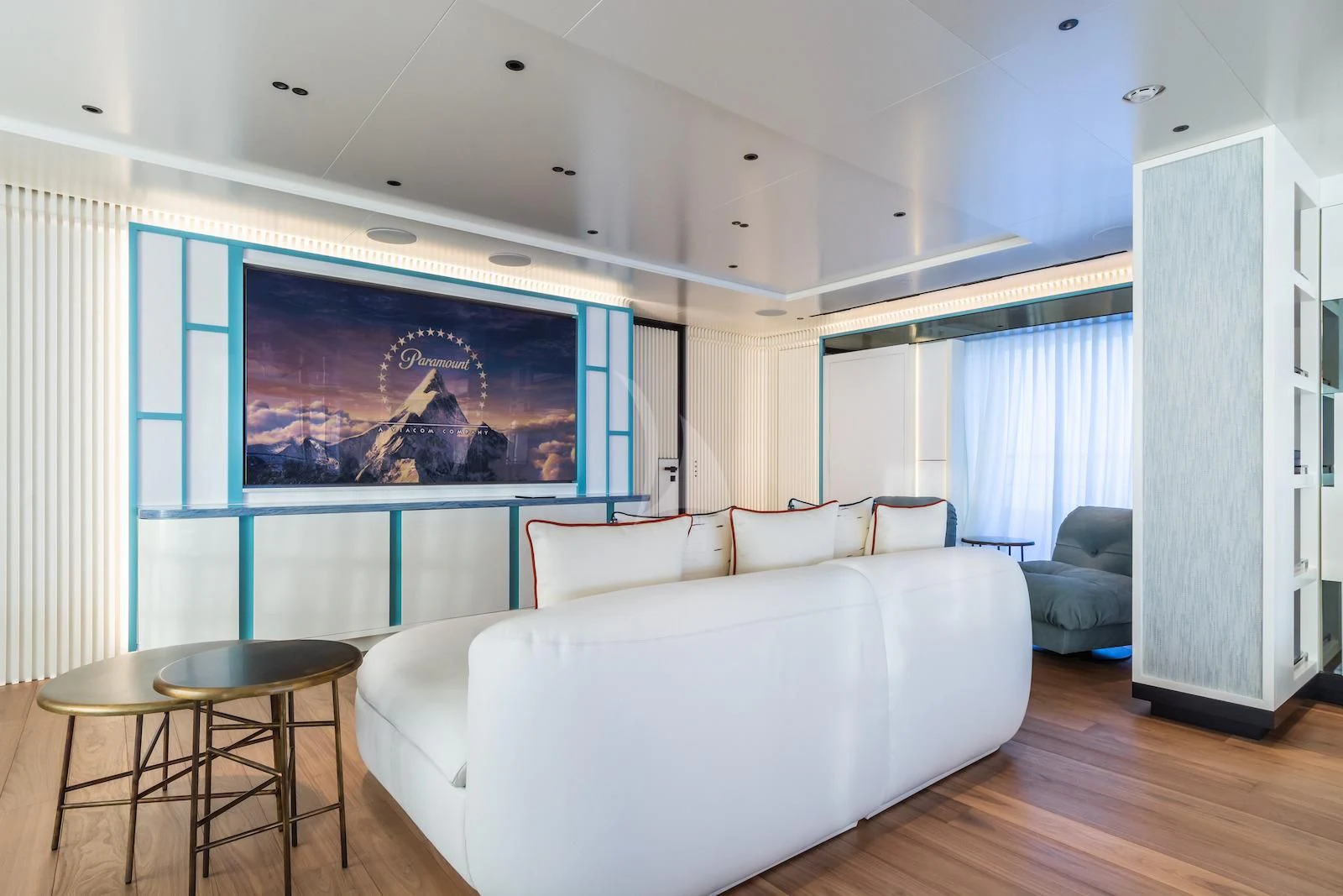 a living room with a large screen aboard RIO Yacht for Sale
