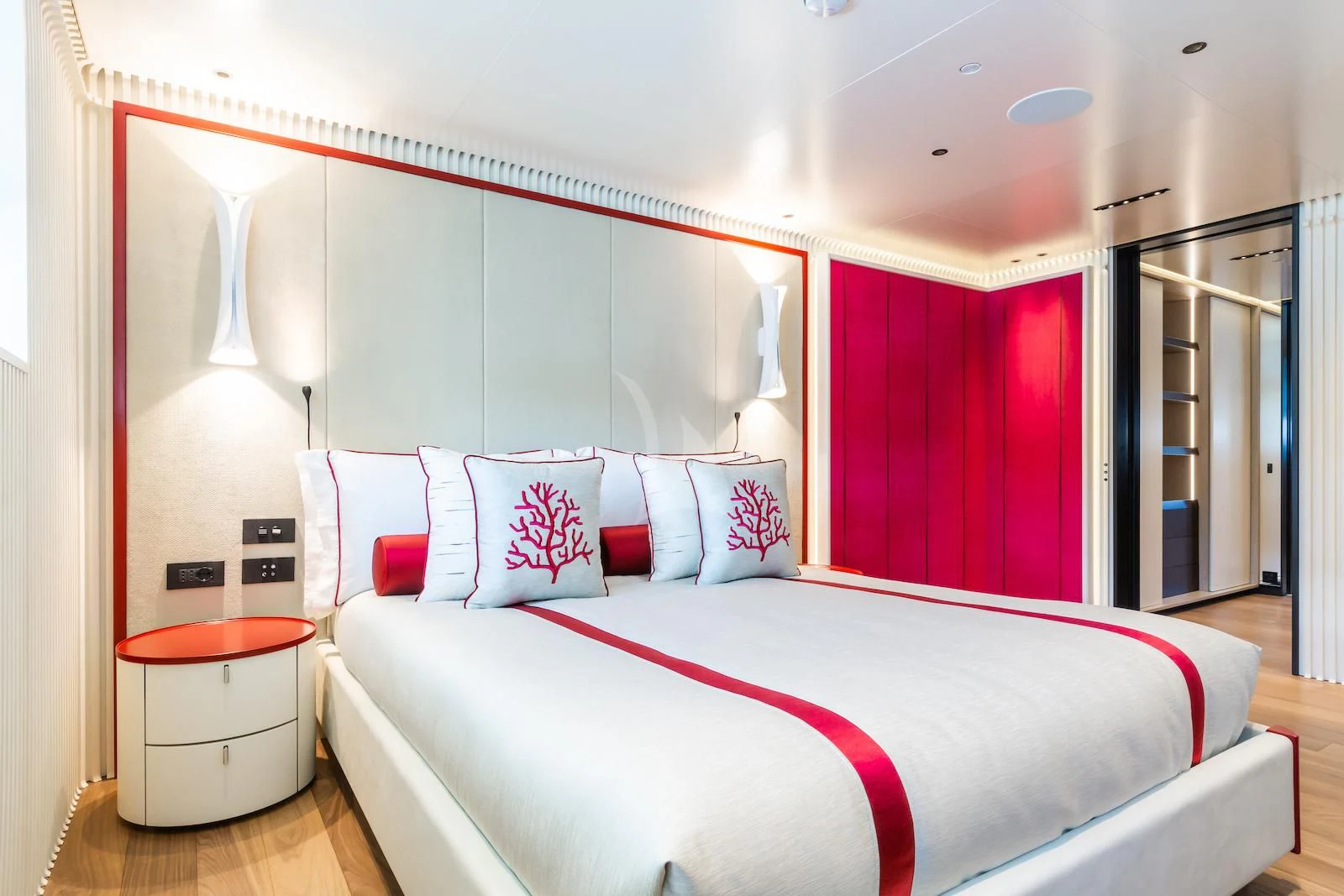 a bed with a pink and white bed spread aboard RIO Yacht for Sale