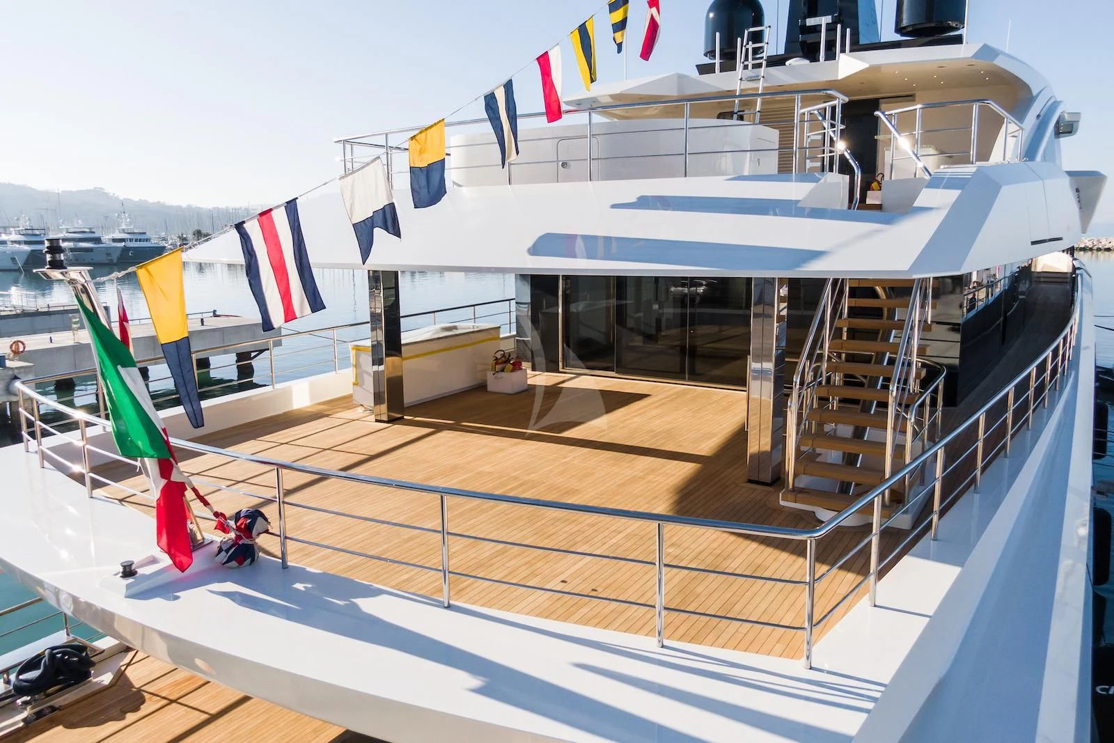 a large white boat with flags aboard RIO Yacht for Sale
