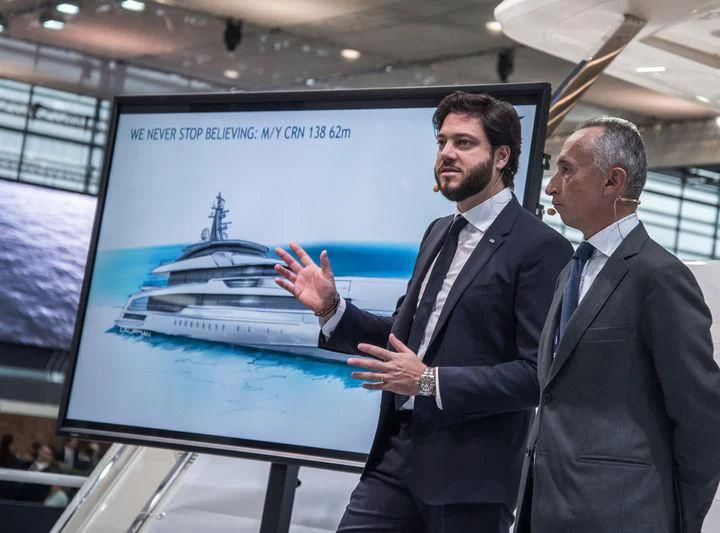 men shaking hands in front of a screen aboard RIO Yacht for Sale