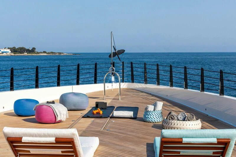 a deck with a slide and a chair on it aboard RIO Yacht for Sale
