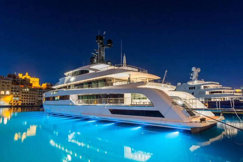 a large white boat in a harbor aboard RIO Yacht for Sale