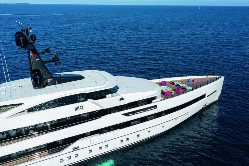 a white yacht with a black motor aboard RIO Yacht for Sale