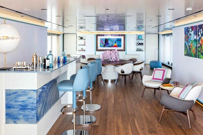 a room with tables and chairs aboard RIO Yacht for Sale