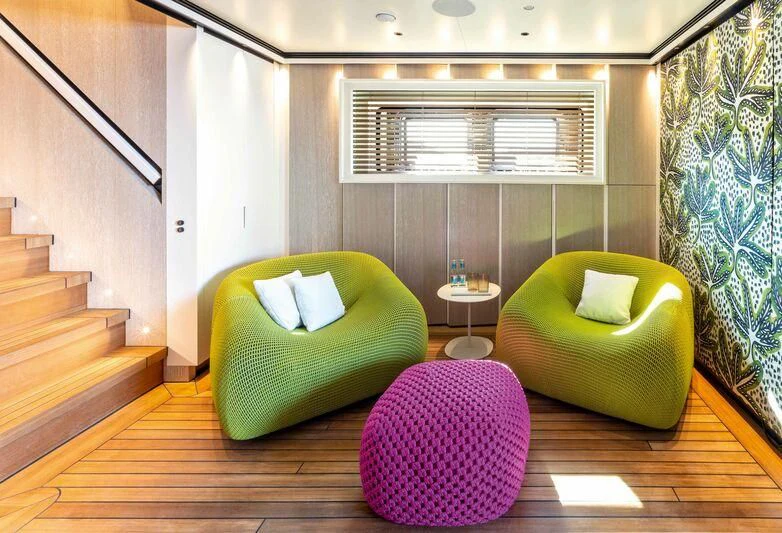 a living room with a couch and a staircase aboard RIO Yacht for Sale