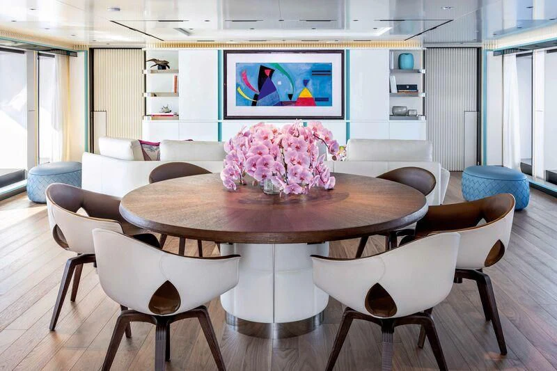 a room with a table and chairs aboard RIO Yacht for Sale