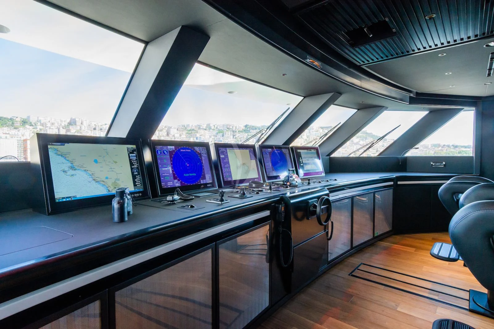 a row of computer screens on a table aboard RIO Yacht for Sale