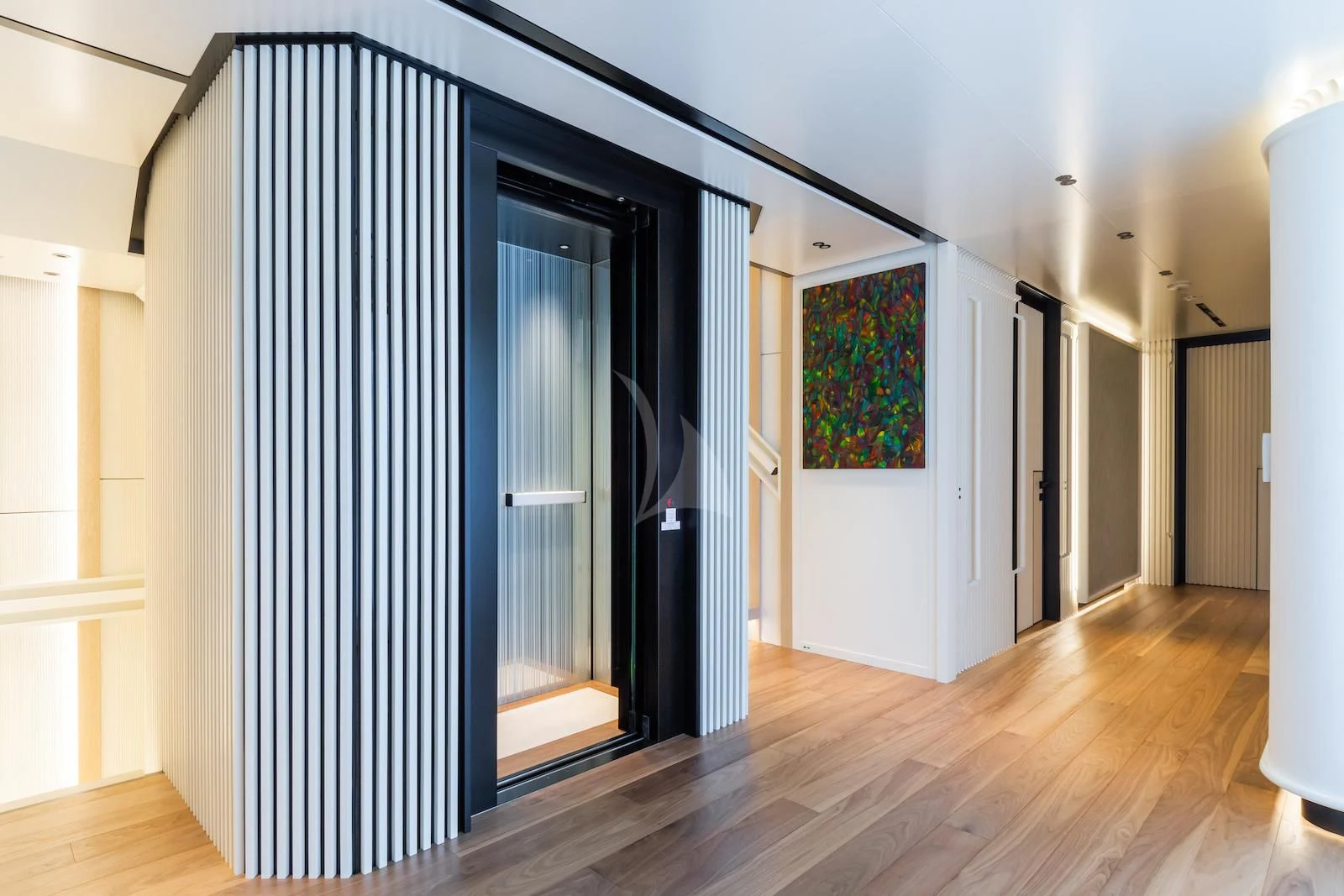 a room with a door and a painting on the wall aboard RIO Yacht for Sale