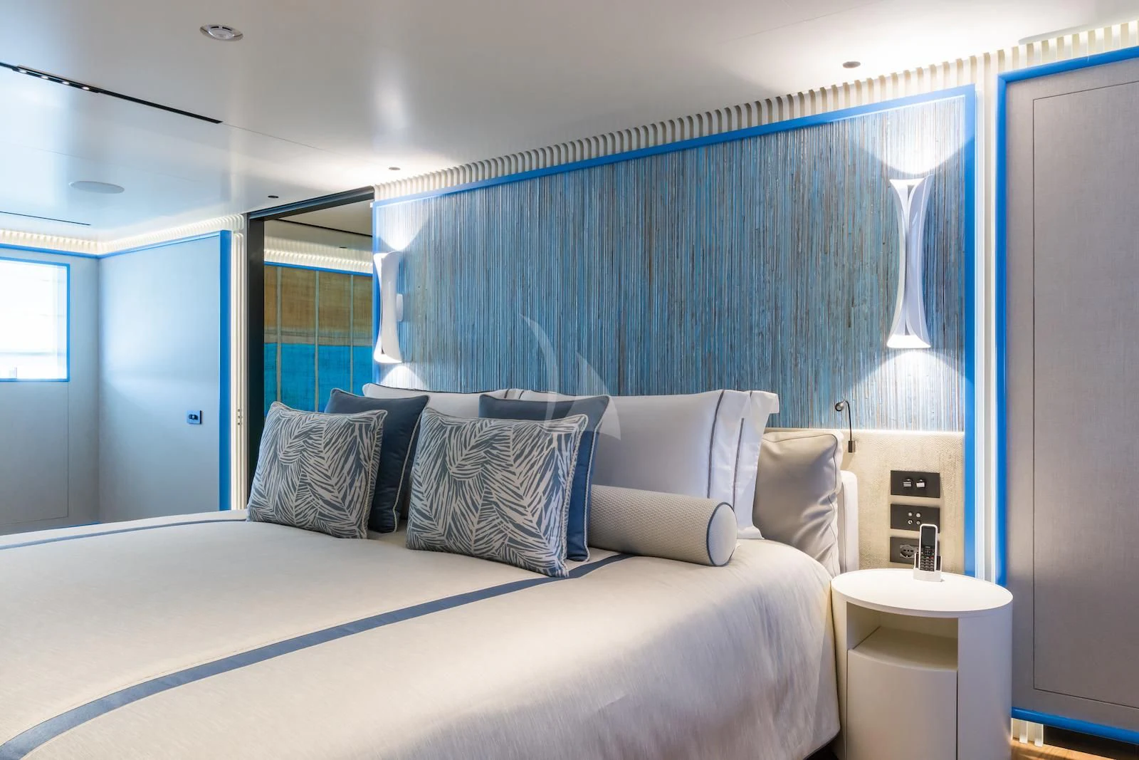 a bed with a white bed spread aboard RIO Yacht for Sale