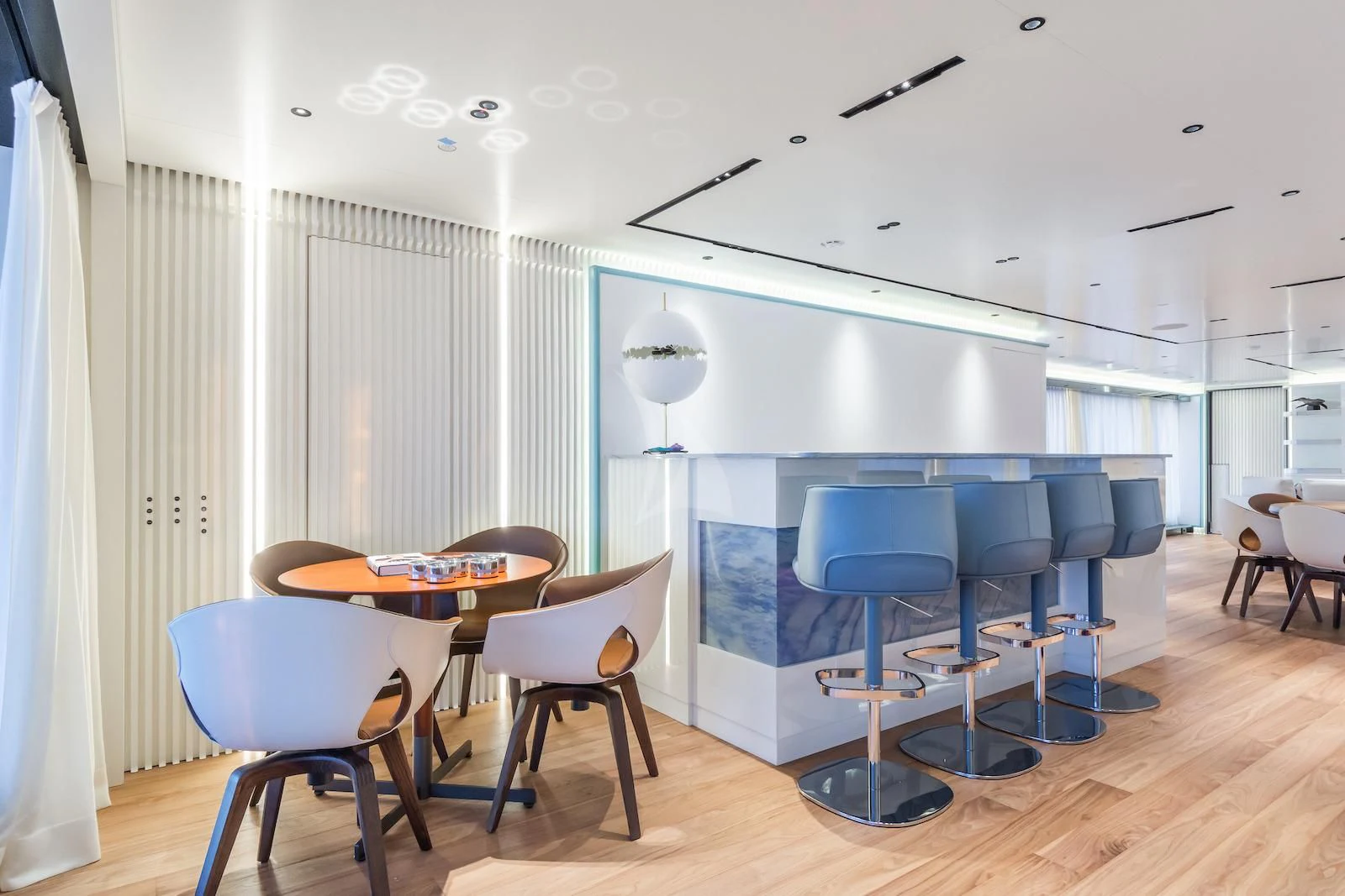 a room with a table and chairs aboard RIO Yacht for Sale