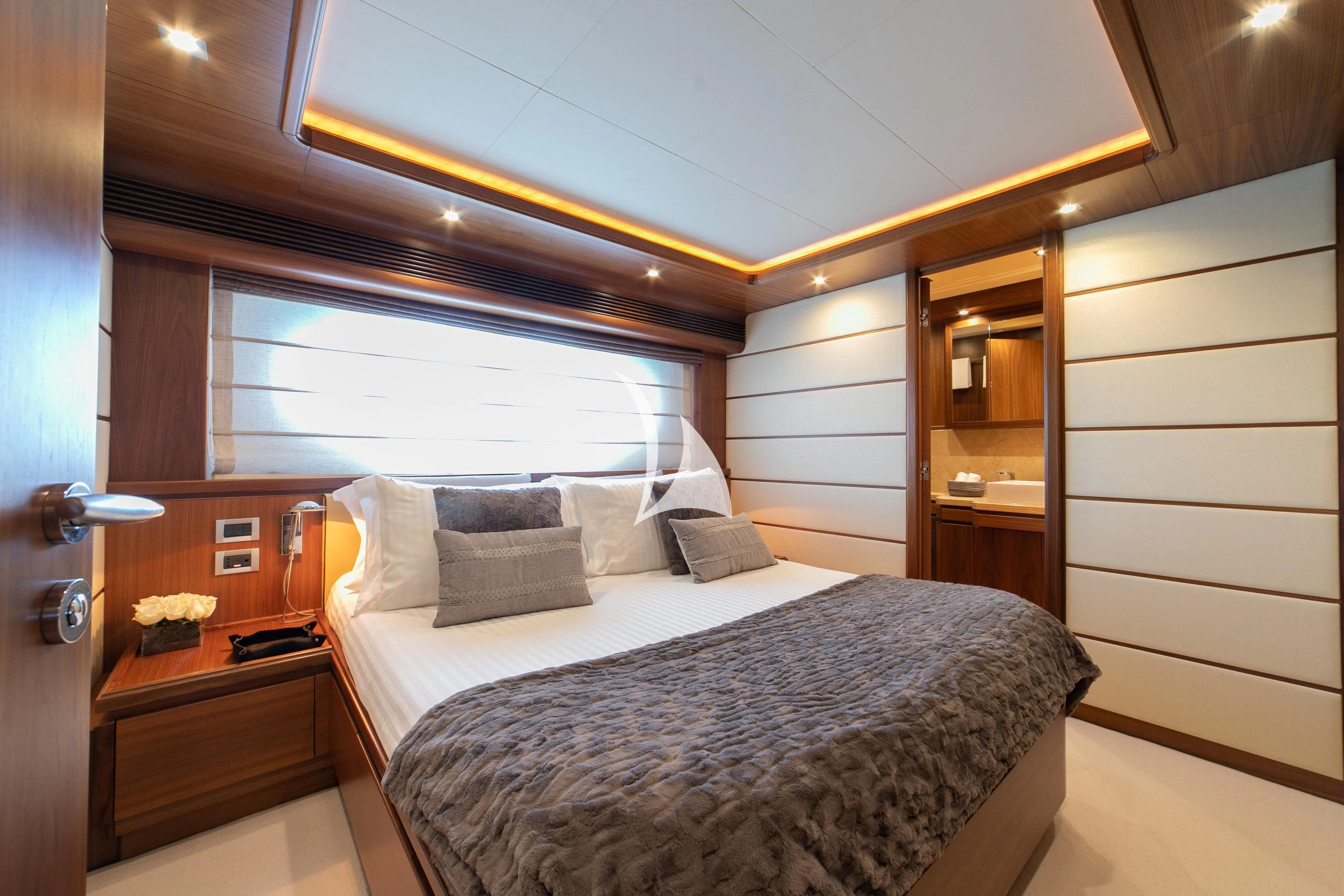 a bedroom with a bed and a window aboard ETHNA Yacht for Sale