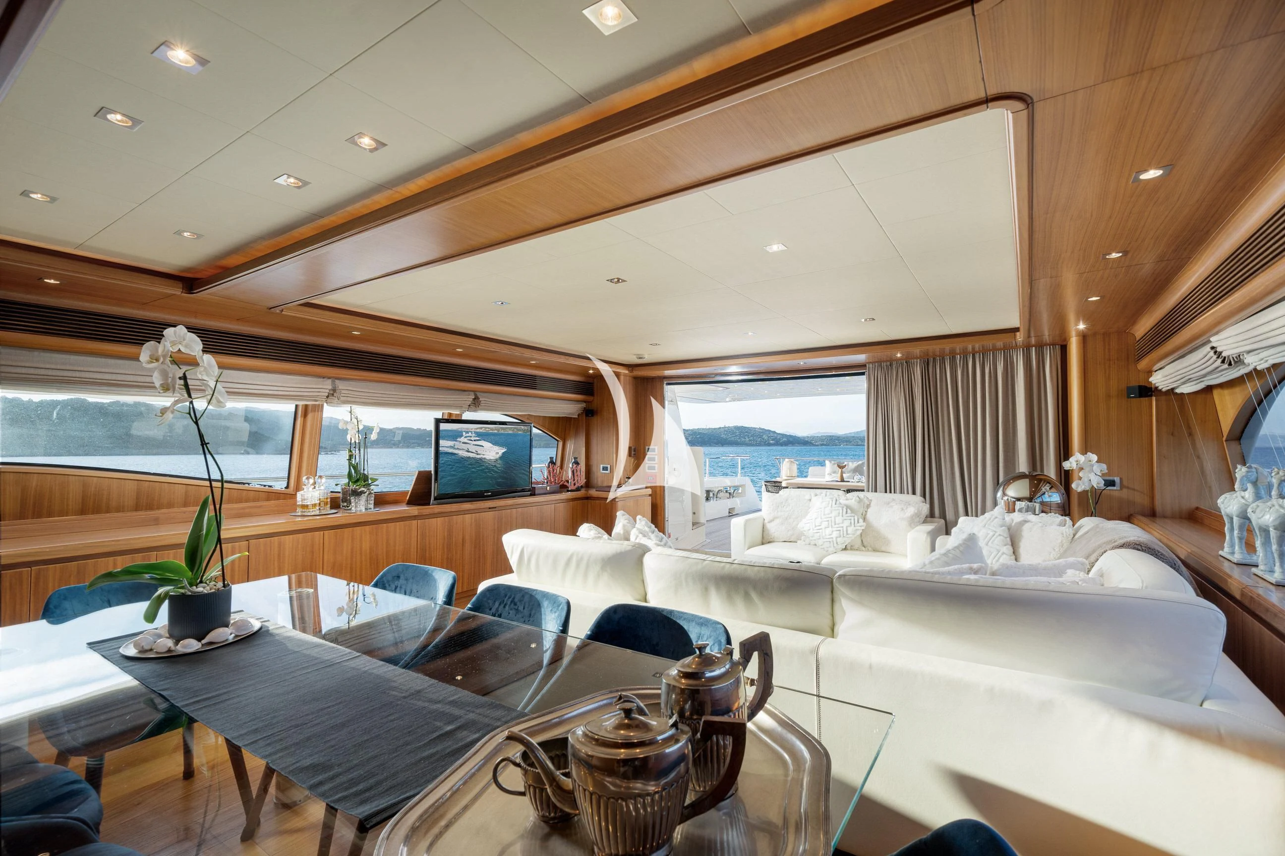 a room with a couch and a table and chairs aboard ETHNA Yacht for Sale