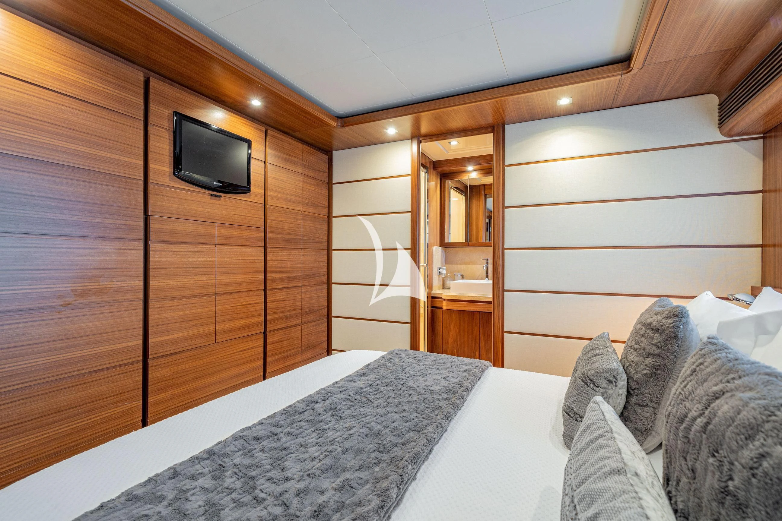 a bedroom with a bed and a television aboard ETHNA Yacht for Sale