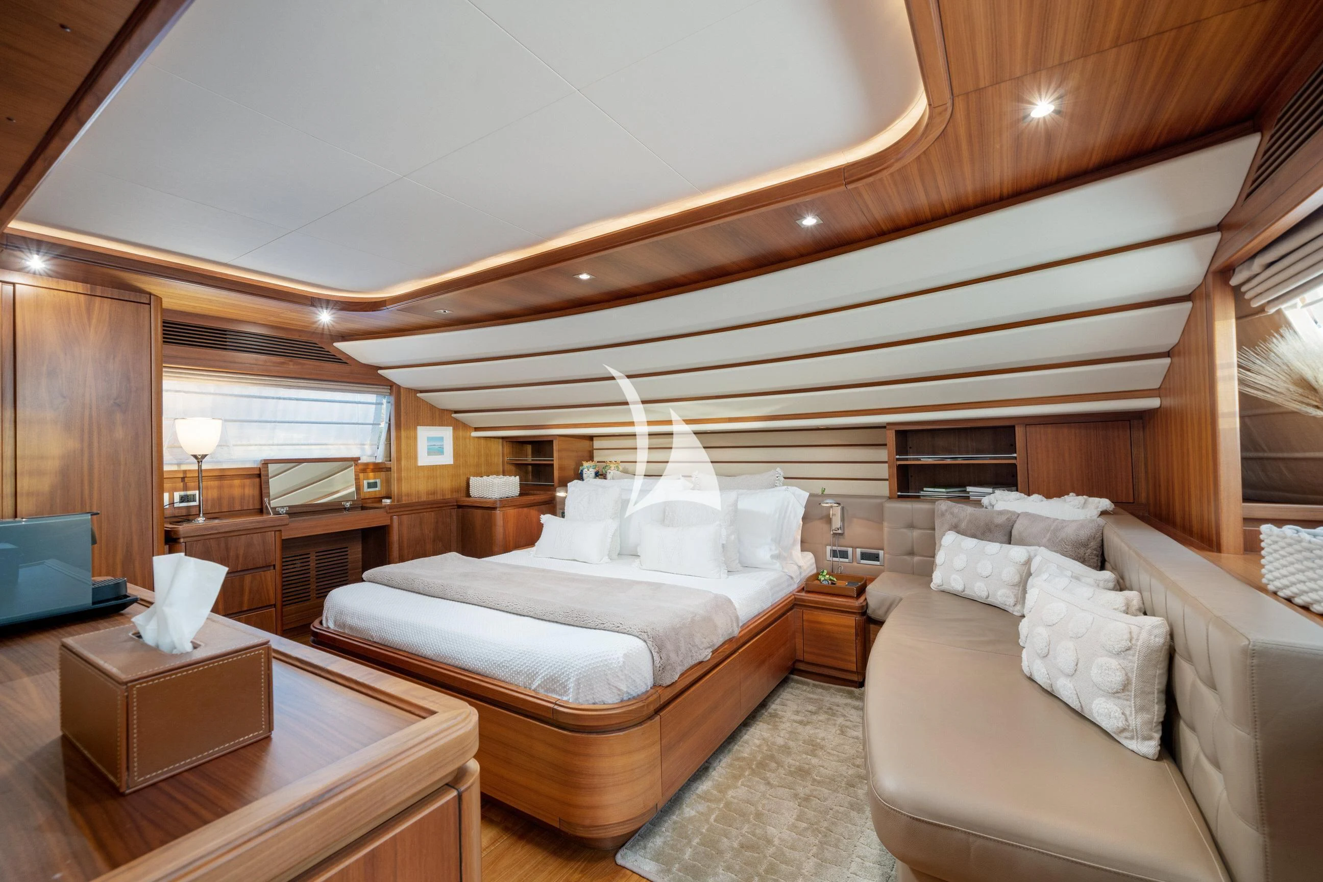 a bedroom with a bed and a couch aboard ETHNA Yacht for Sale