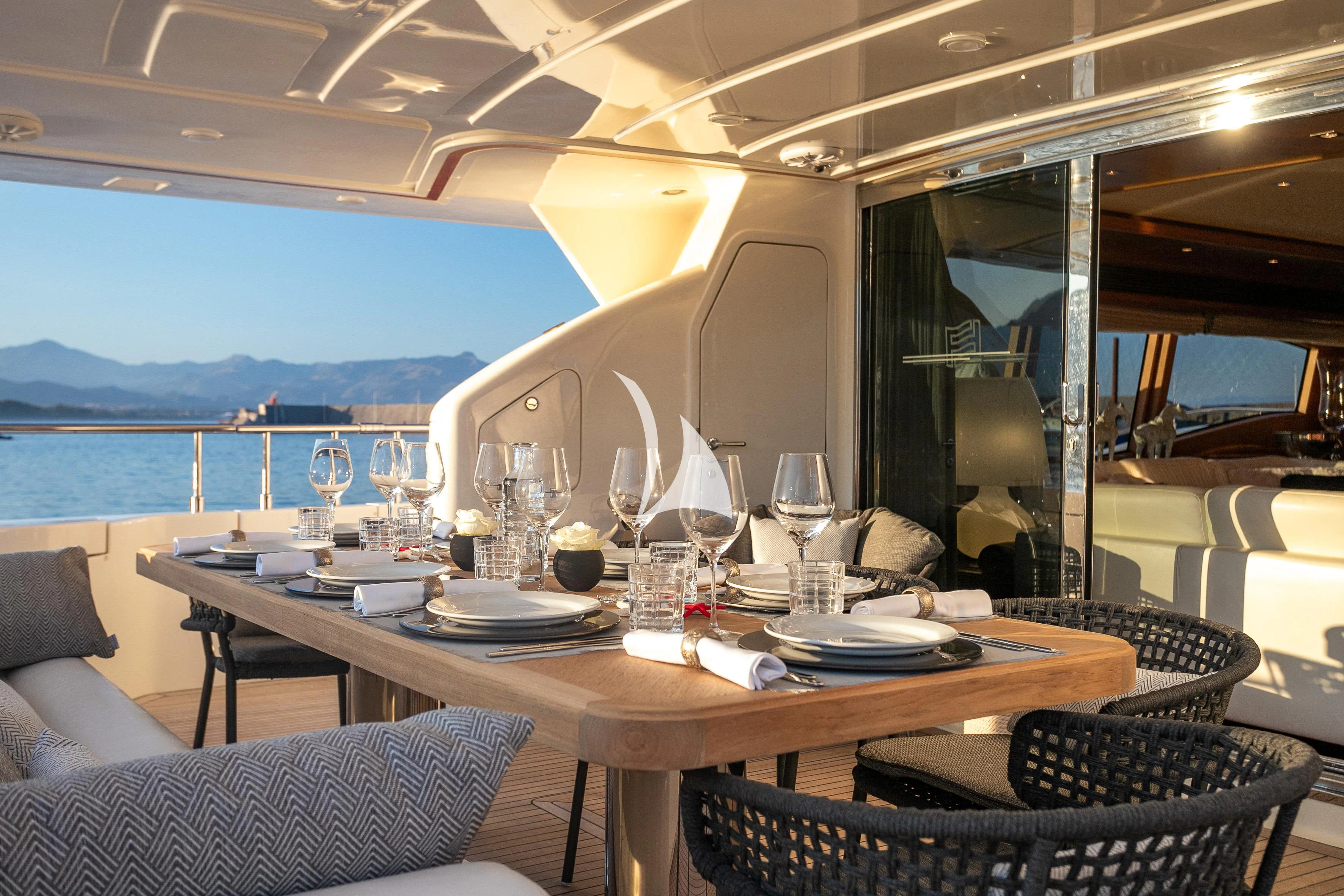 a table with plates and glasses on it aboard ETHNA Yacht for Sale