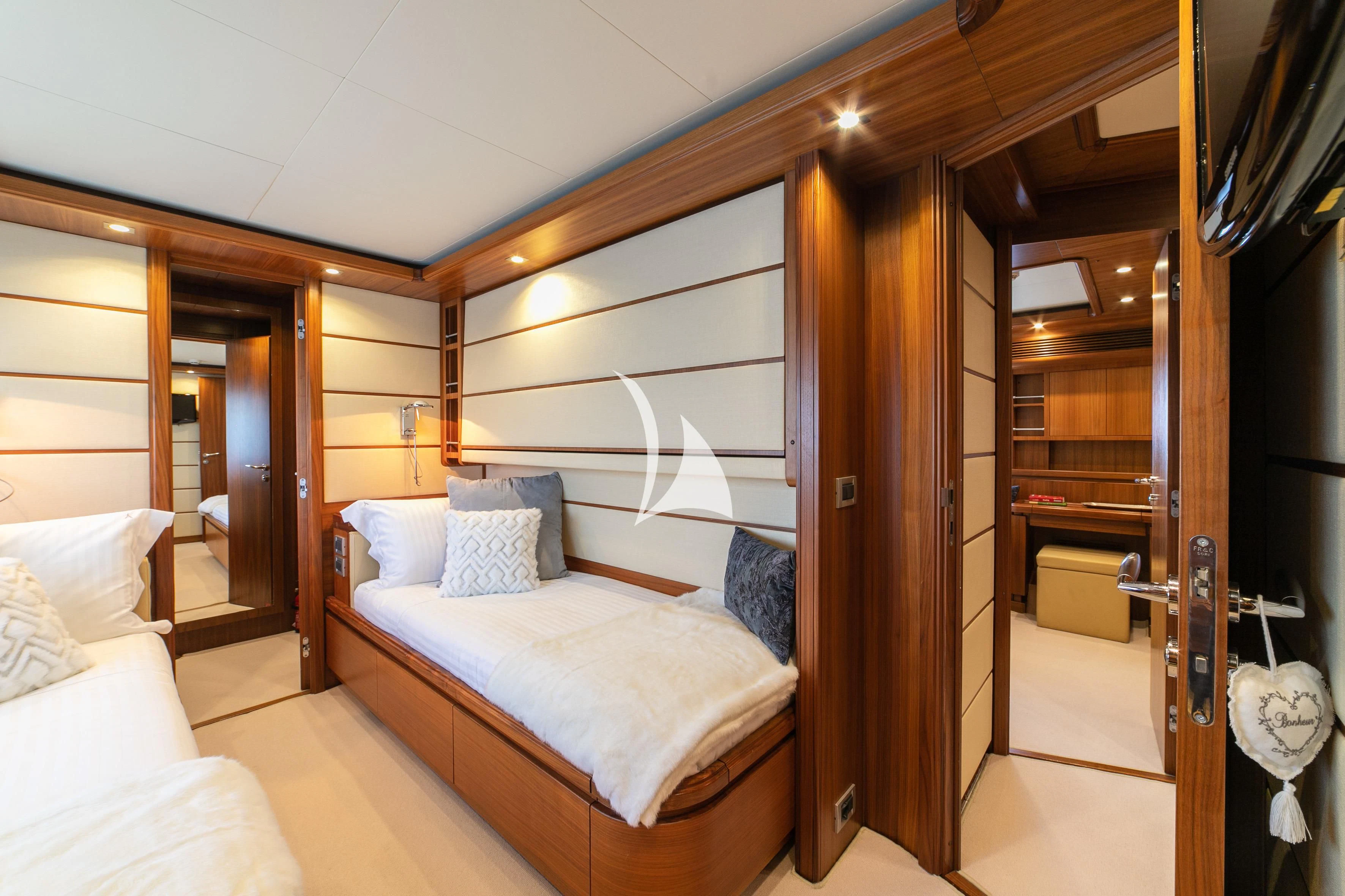 a room with a bed and a mirror aboard ETHNA Yacht for Sale