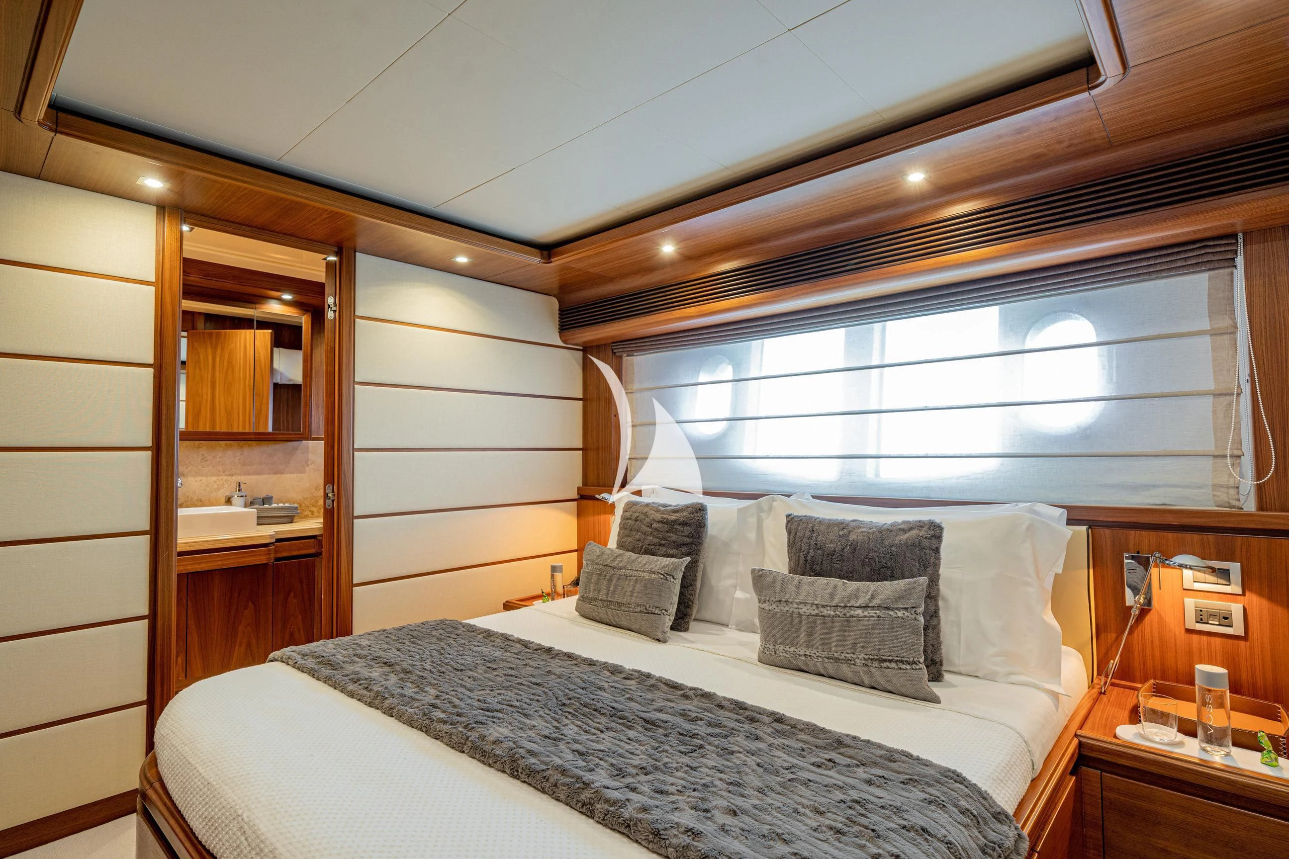 a bed with a white bed spread aboard ETHNA Yacht for Sale