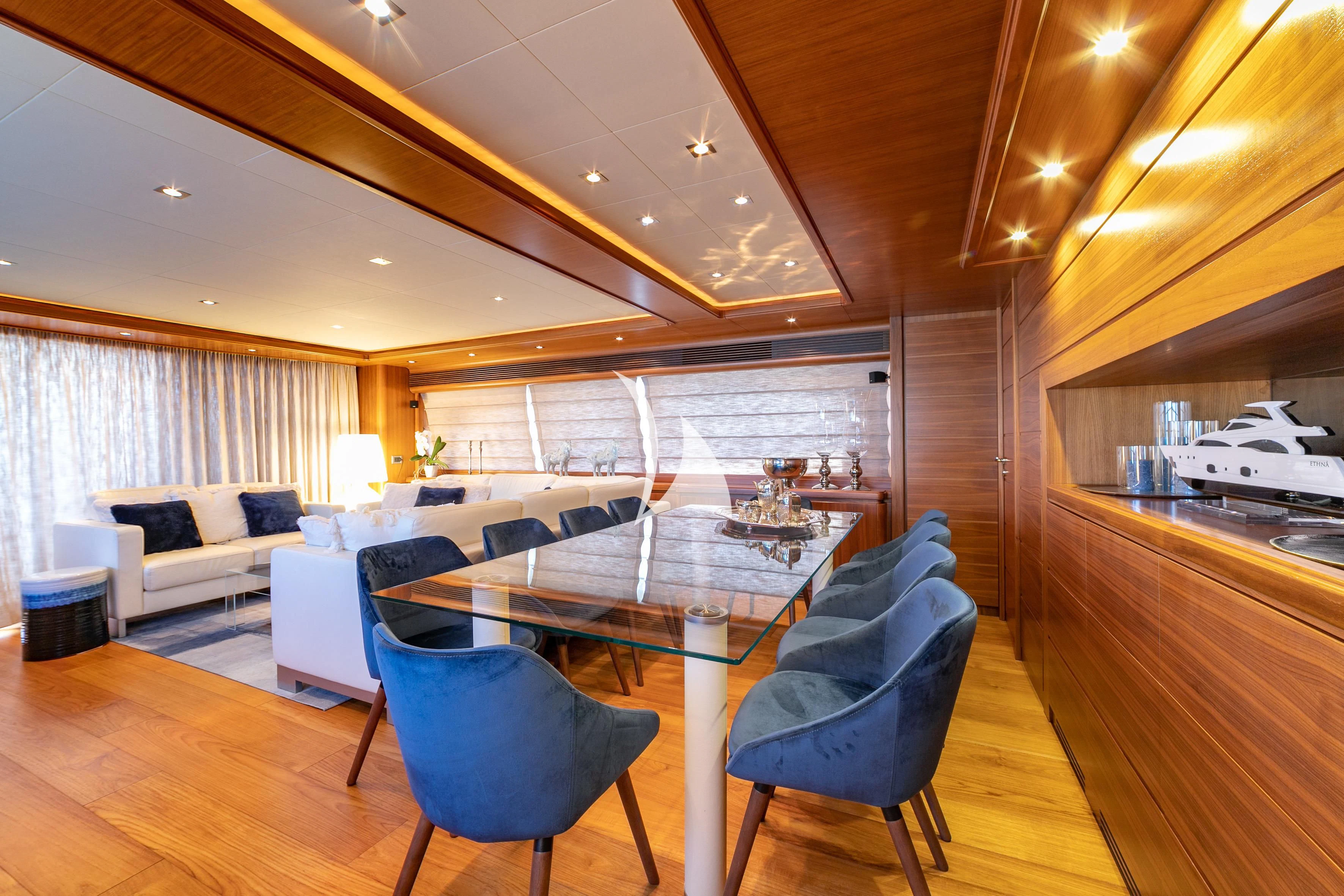 a room with a table chairs and a couch aboard ETHNA Yacht for Sale