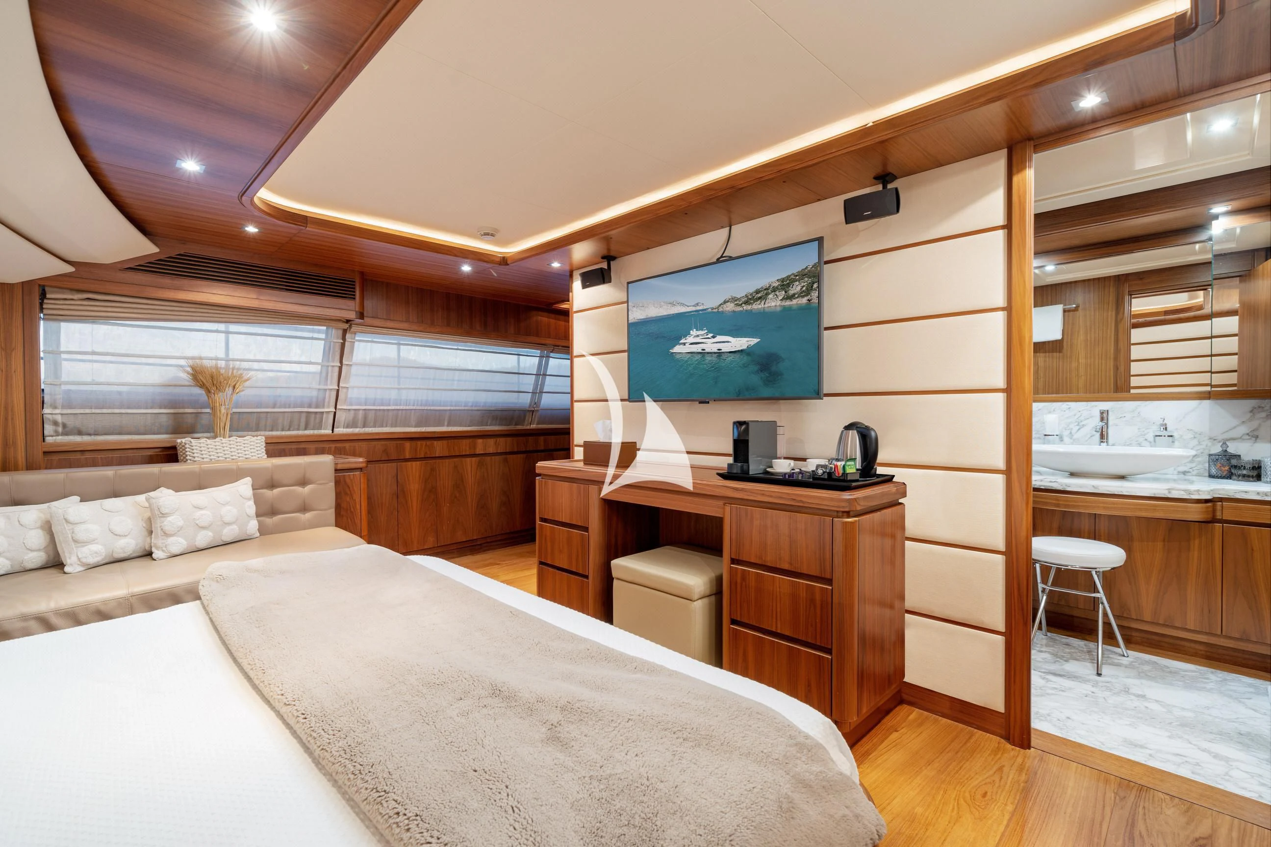 a bedroom with a bed and a desk aboard ETHNA Yacht for Sale