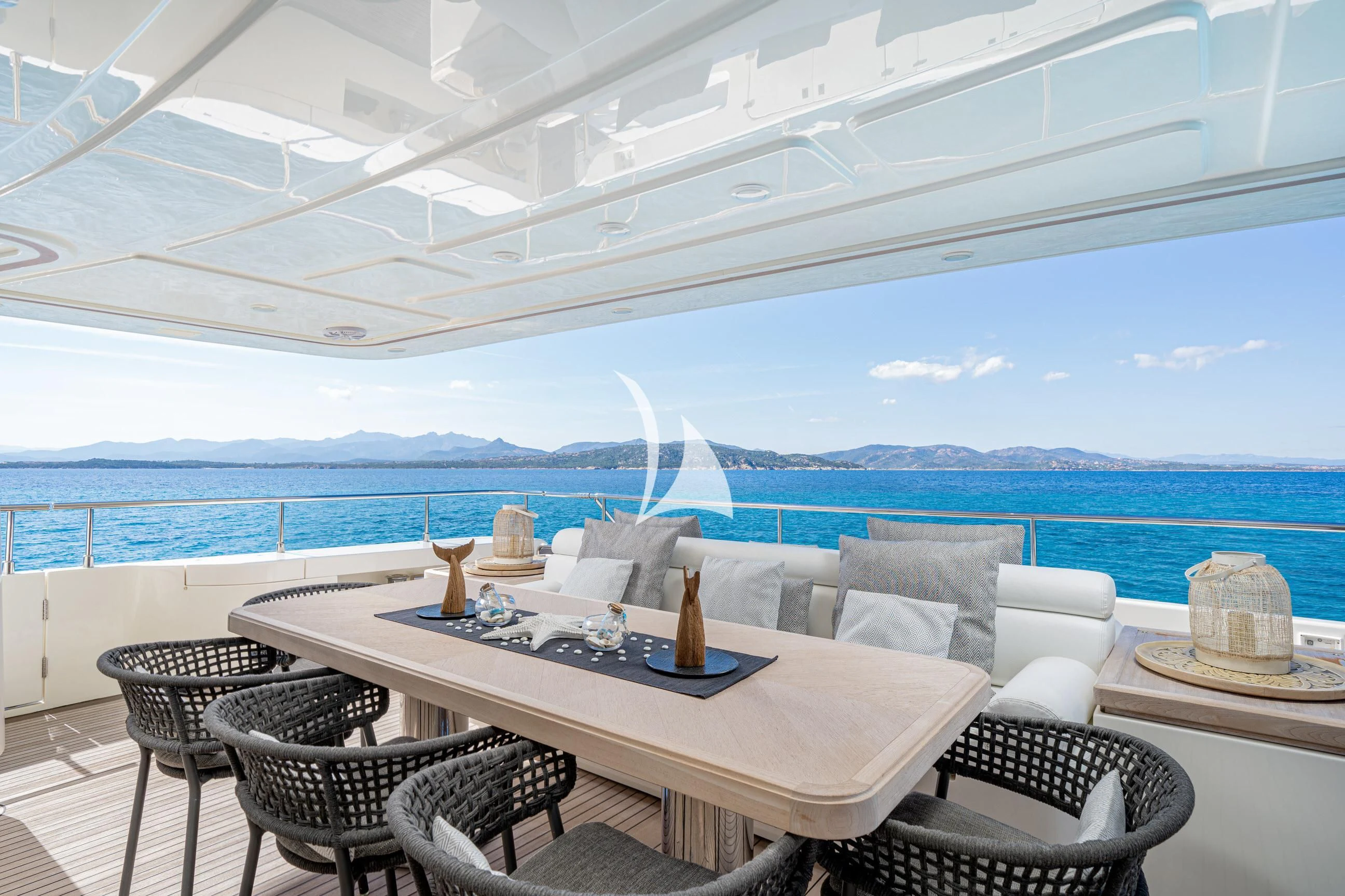 a table and chairs on a patio aboard ETHNA Yacht for Sale