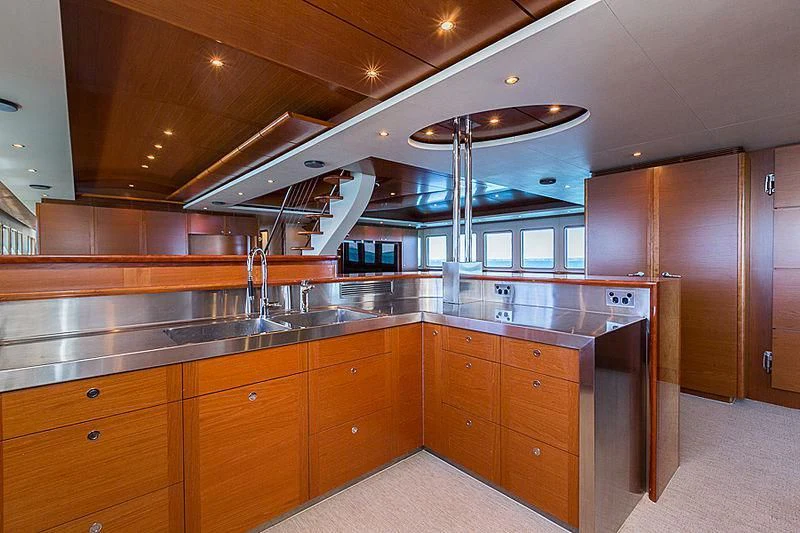 a kitchen with wooden cabinets aboard ZIG ZAG Yacht for Sale