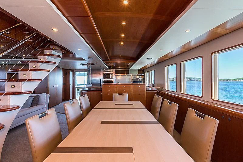 a large room with a table and chairs aboard ZIG ZAG Yacht for Sale