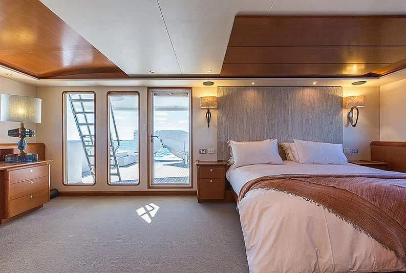 a bedroom with a bed and a desk aboard ZIG ZAG Yacht for Sale