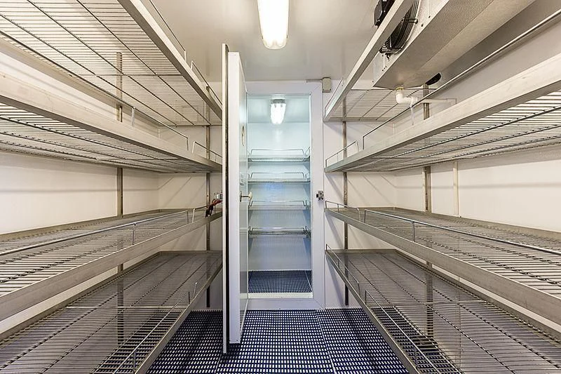 a long hallway with a blue door aboard ZIG ZAG Yacht for Sale
