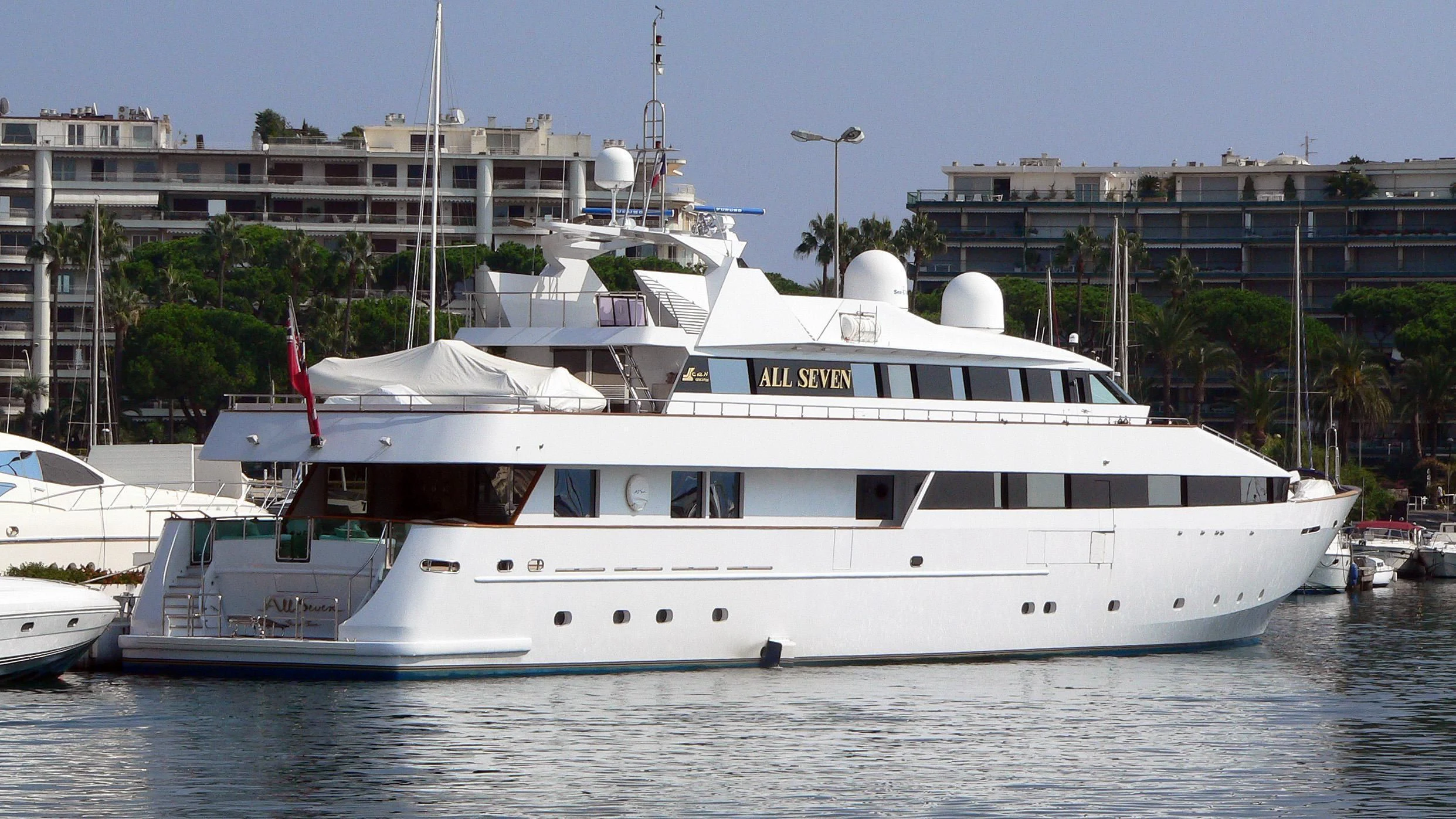 a white yacht in a harbor aboard ALL SEVEN Yacht for Sale