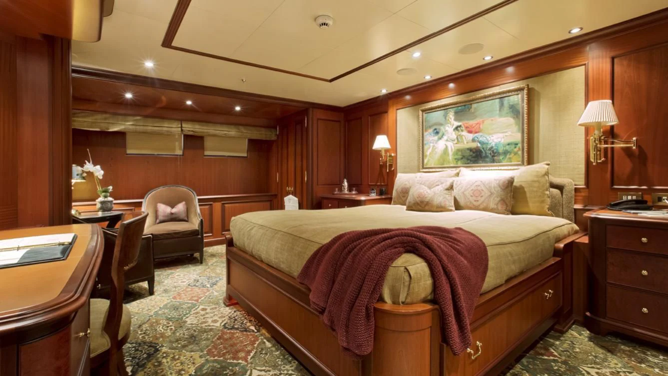 a bedroom with a bed and a chair aboard VIXIT Yacht for Sale
