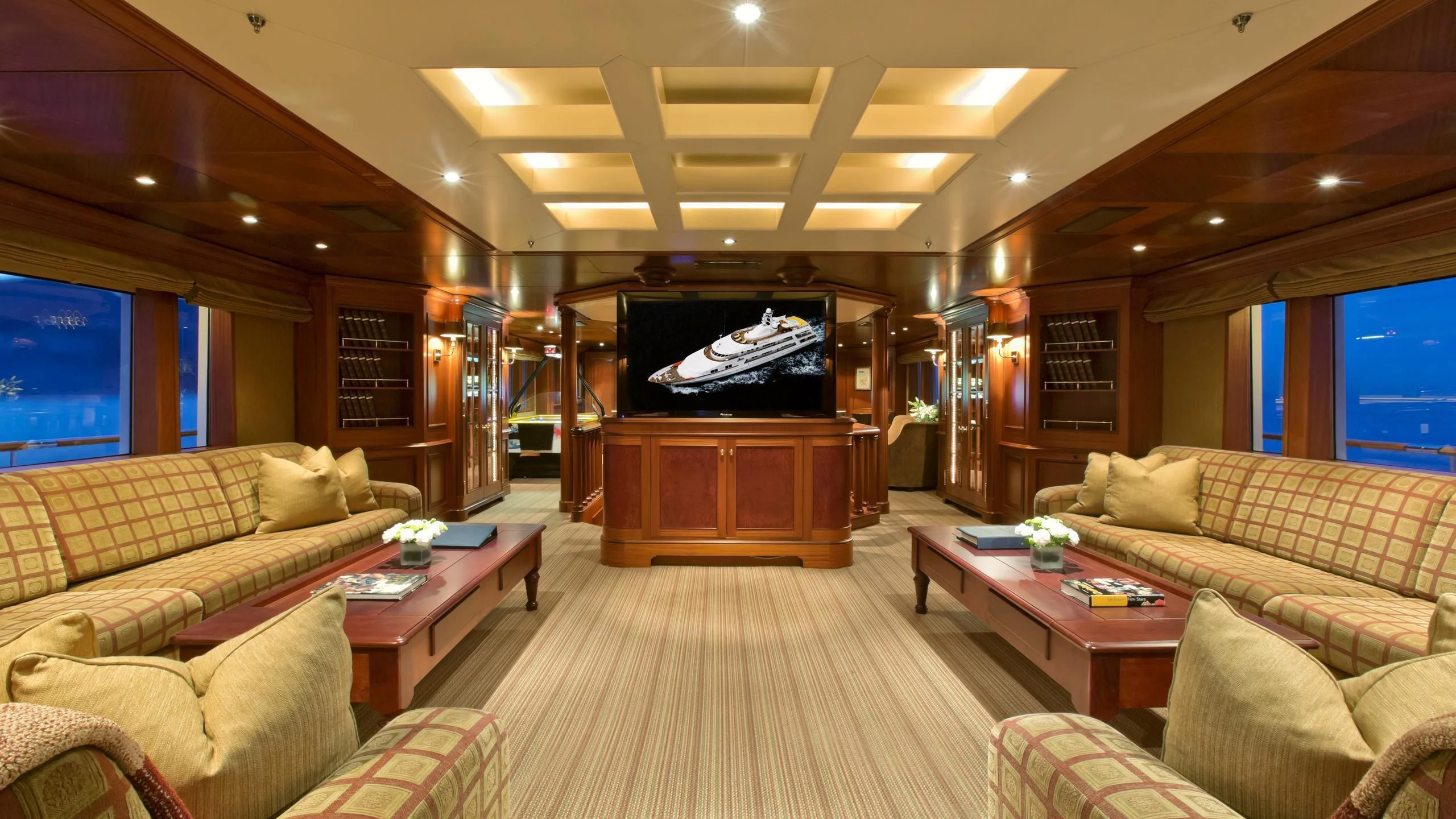 a living room with a large television aboard VIXIT Yacht for Sale