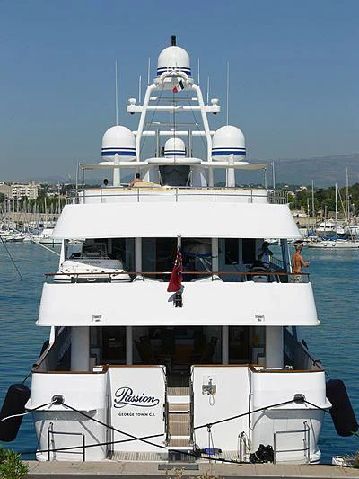 a large white boat with a red ribbon on the front aboard VIXIT Yacht for Sale