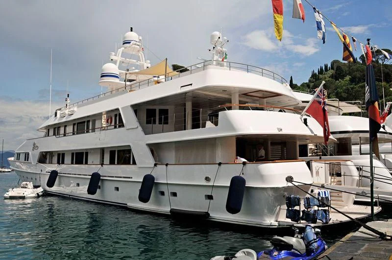 a large white boat with flags aboard VIXIT Yacht for Sale
