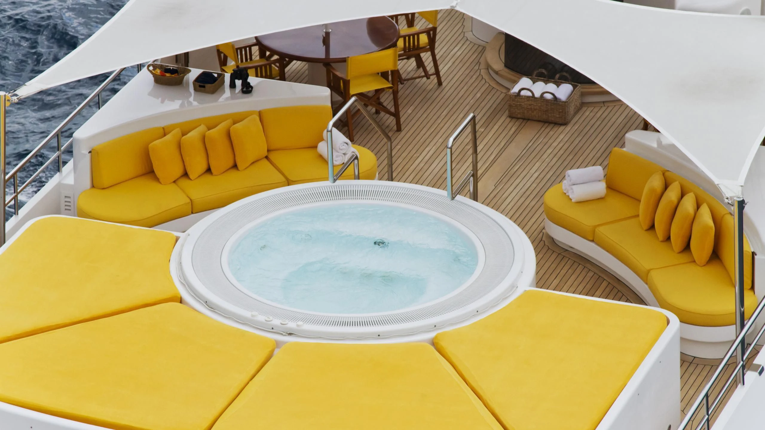 a yellow and white room with a table and chairs and a yellow couch aboard VIXIT Yacht for Sale