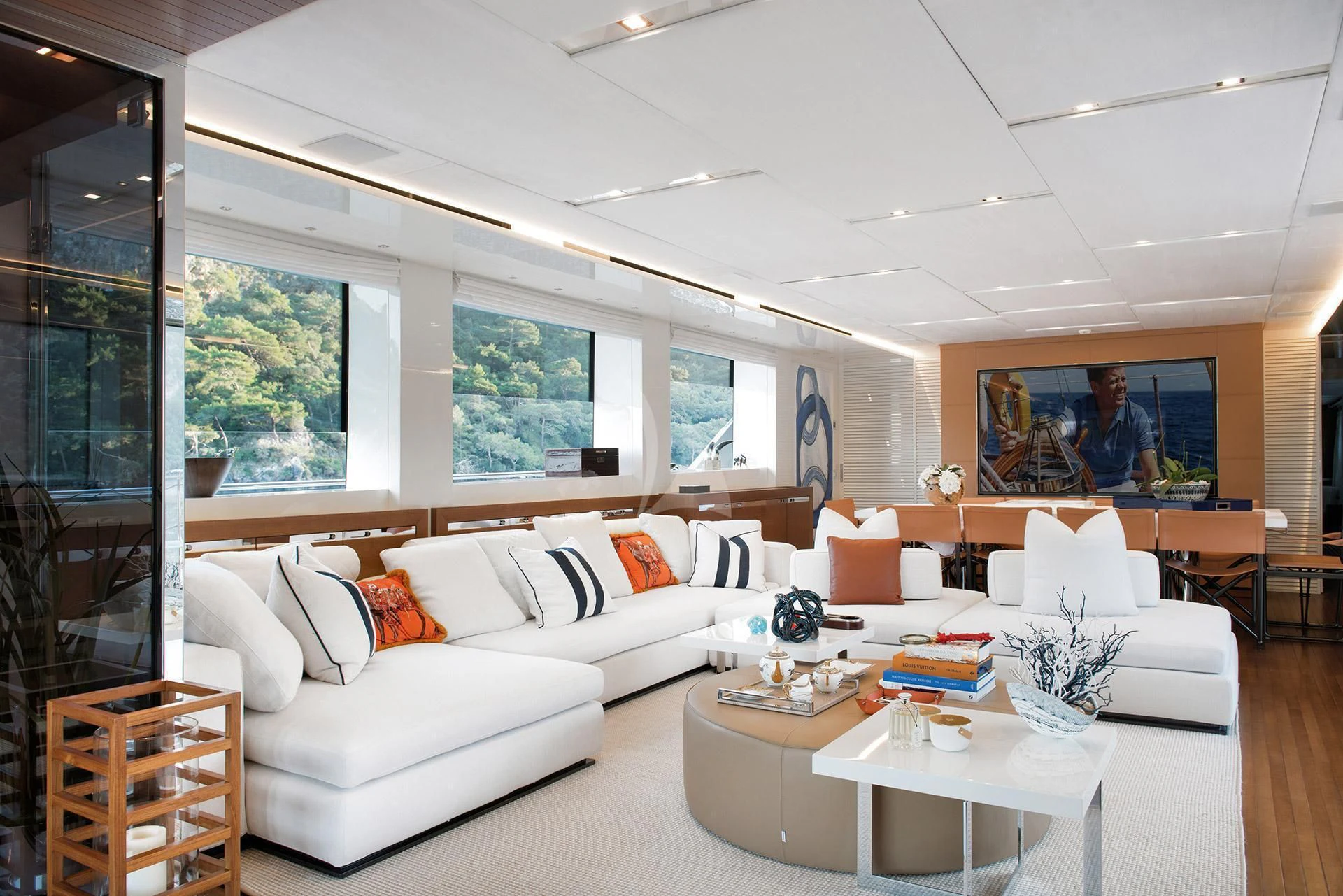 a living room with a white couch and a large window aboard MORNING STAR Yacht for Charter