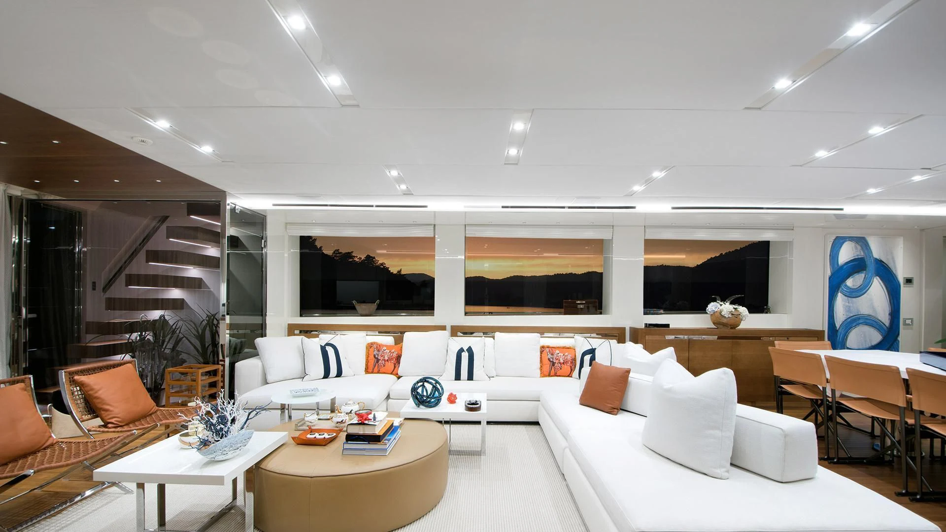 a room with white couches and a large window aboard MORNING STAR Yacht for Charter