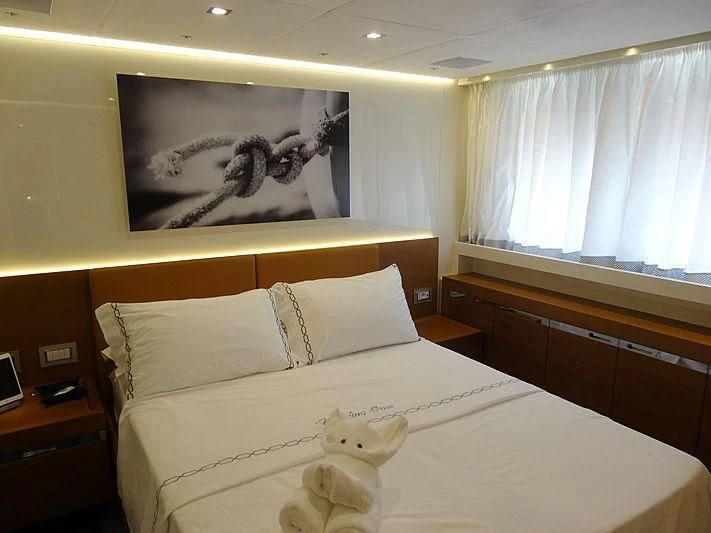 a bed with a stuffed animal aboard MORNING STAR Yacht for Charter