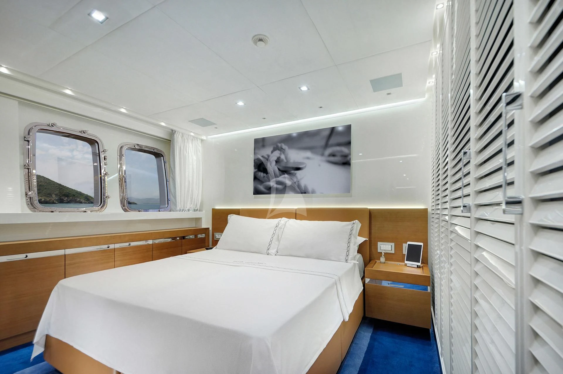 a room with a bed and a mirror aboard MORNING STAR Yacht for Charter