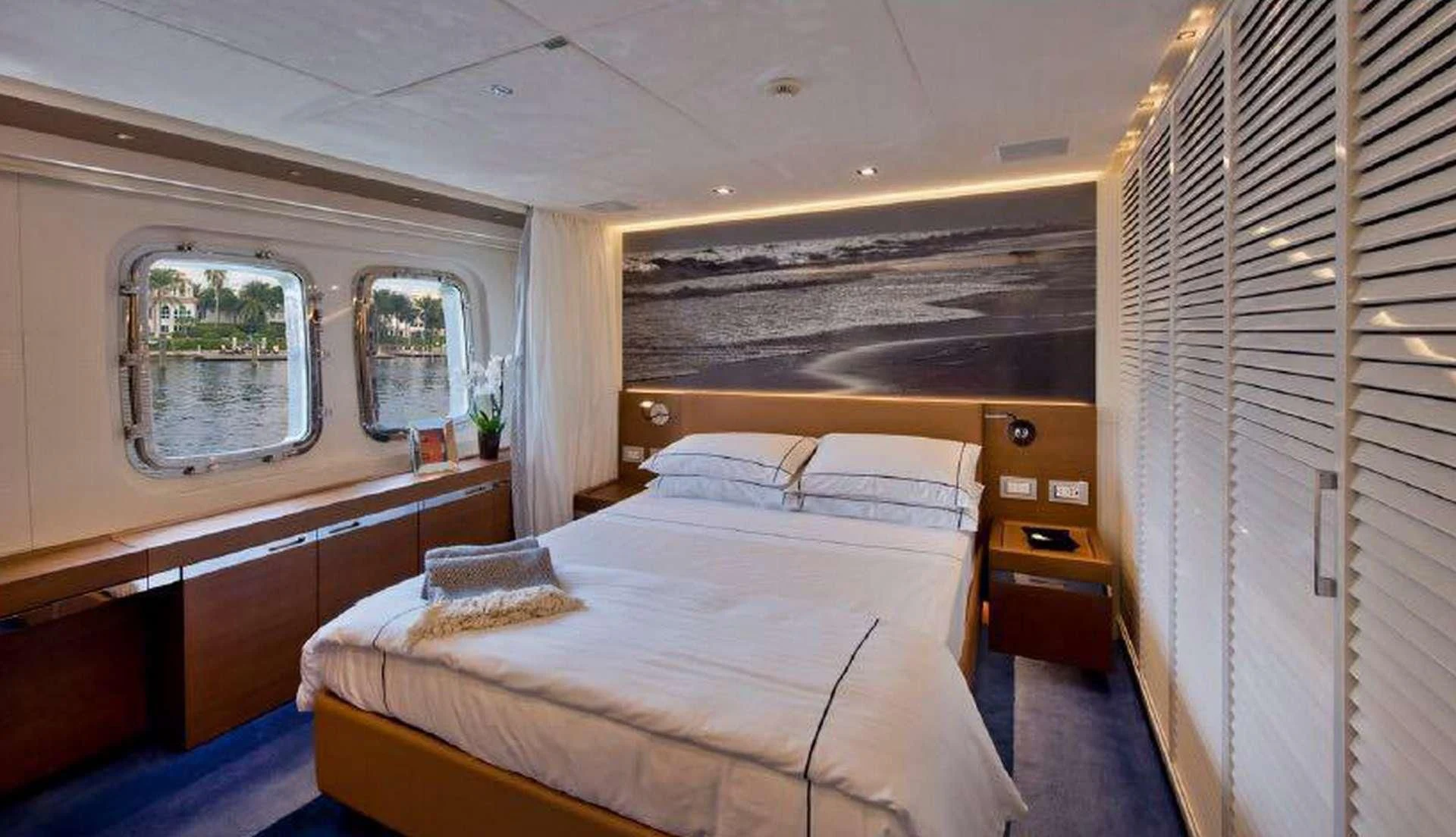 a room with a bed and a window aboard MORNING STAR Yacht for Charter