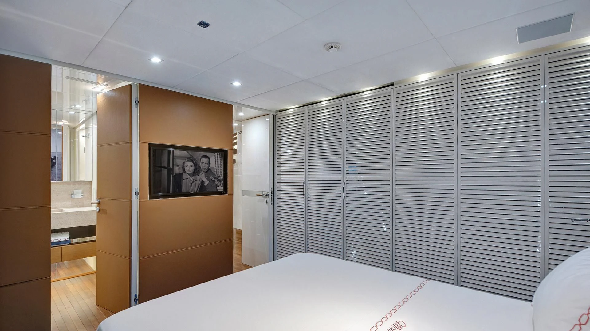 a room with a bed and a television aboard MORNING STAR Yacht for Charter