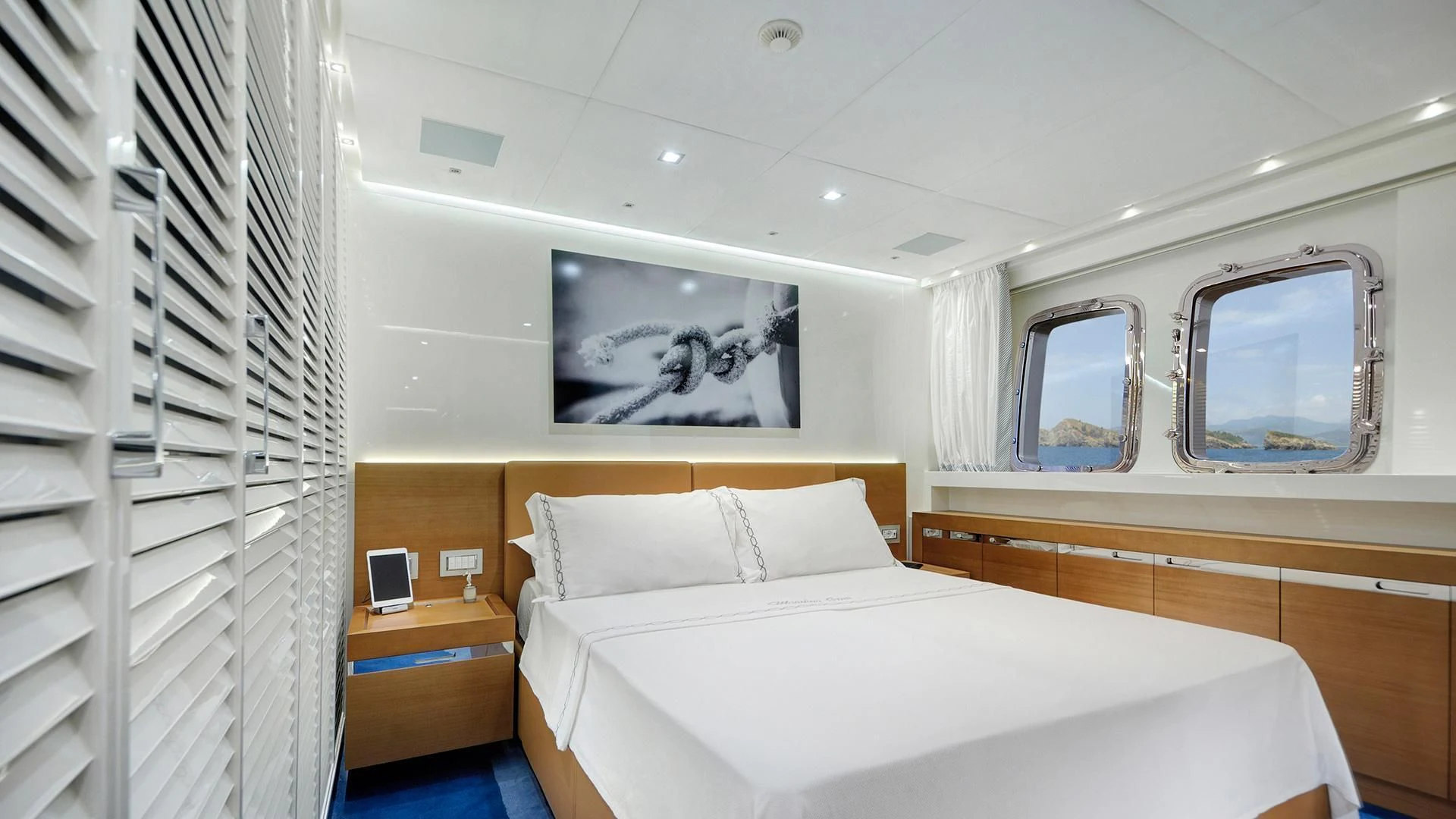 a bedroom with a bed and a mirror aboard MORNING STAR Yacht for Charter
