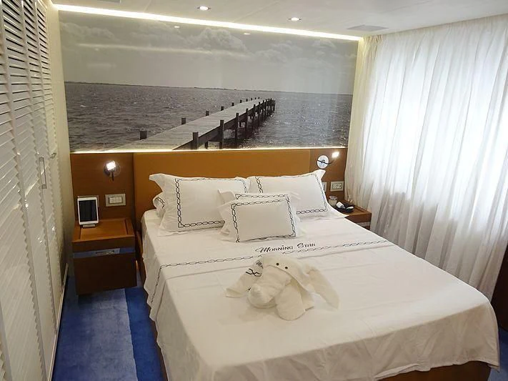 a bed with white sheets aboard MORNING STAR Yacht for Charter